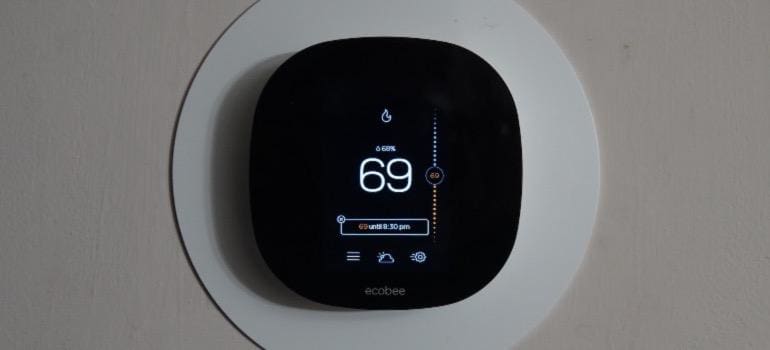 A home thermostat on the wall