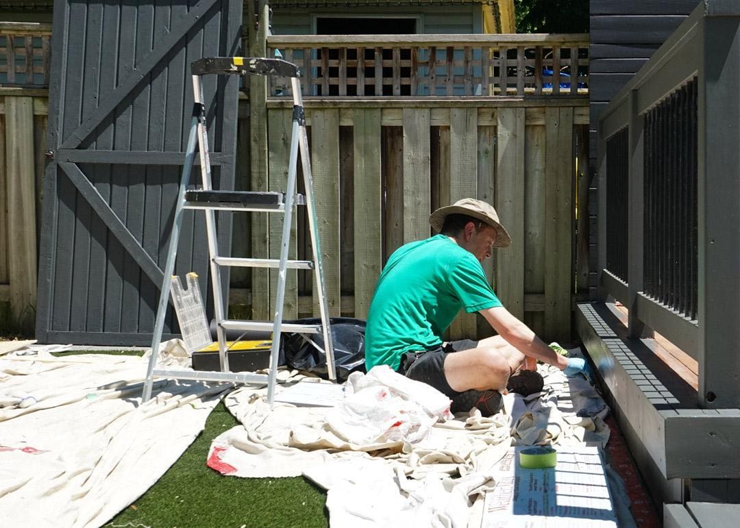 HAndyman with ODDJOB.CA work on refinishingof Decks and Fences in a backyard concierge-plan